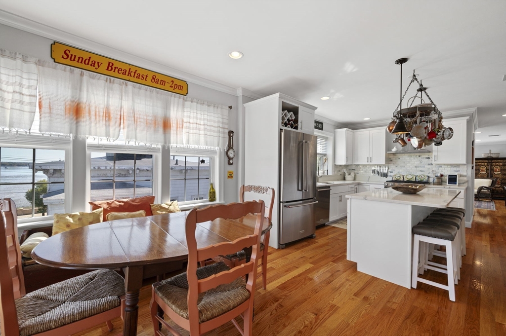 13 Spring Street, Unit 3 Salem, MA 01970 - Photo 16 of 37 a kitchen with a table chairs refrigerator and cabinets
