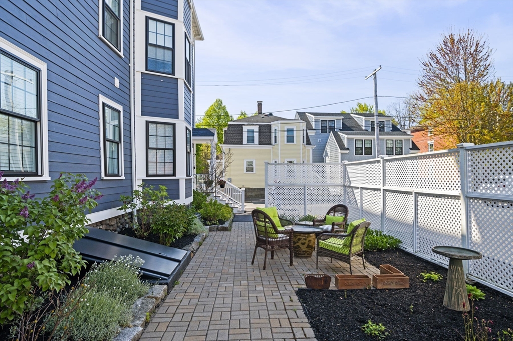 13 Spring Street, Unit 3 Salem, MA 01970 - Photo 2 of 37 a view of a tables and chairs in back yard of the house