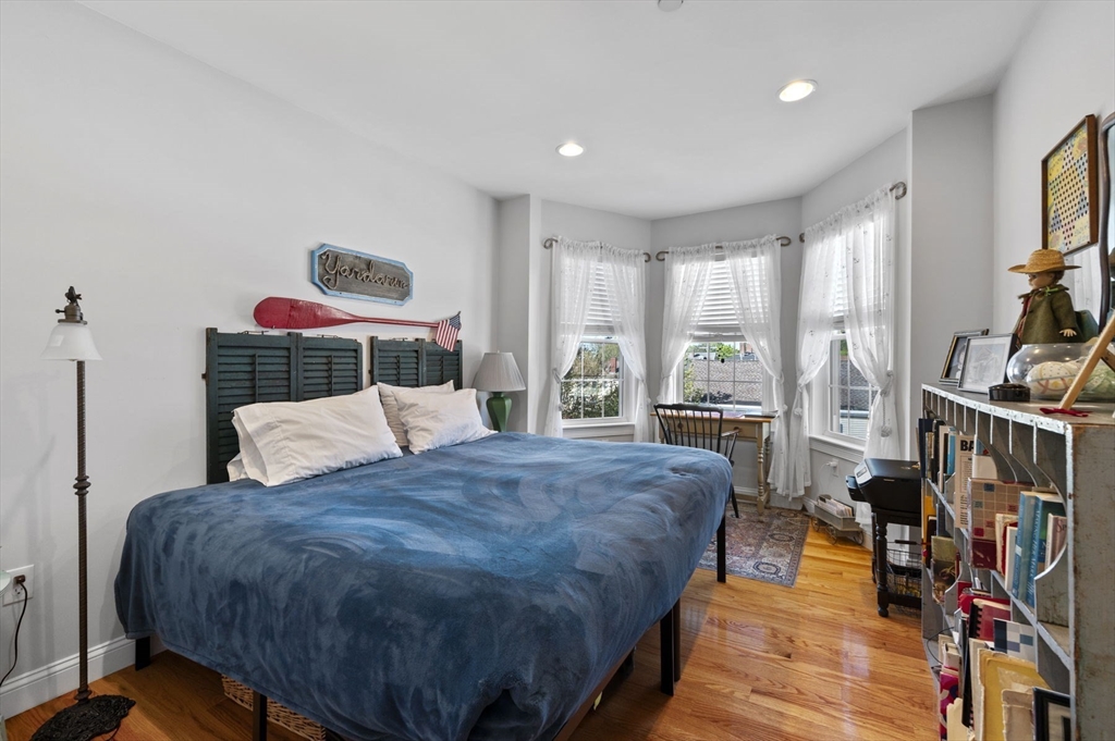 13 Spring Street, Unit 3 Salem, MA 01970 - Photo 21 of 37 a bedroom with a bed a dresser and a large window