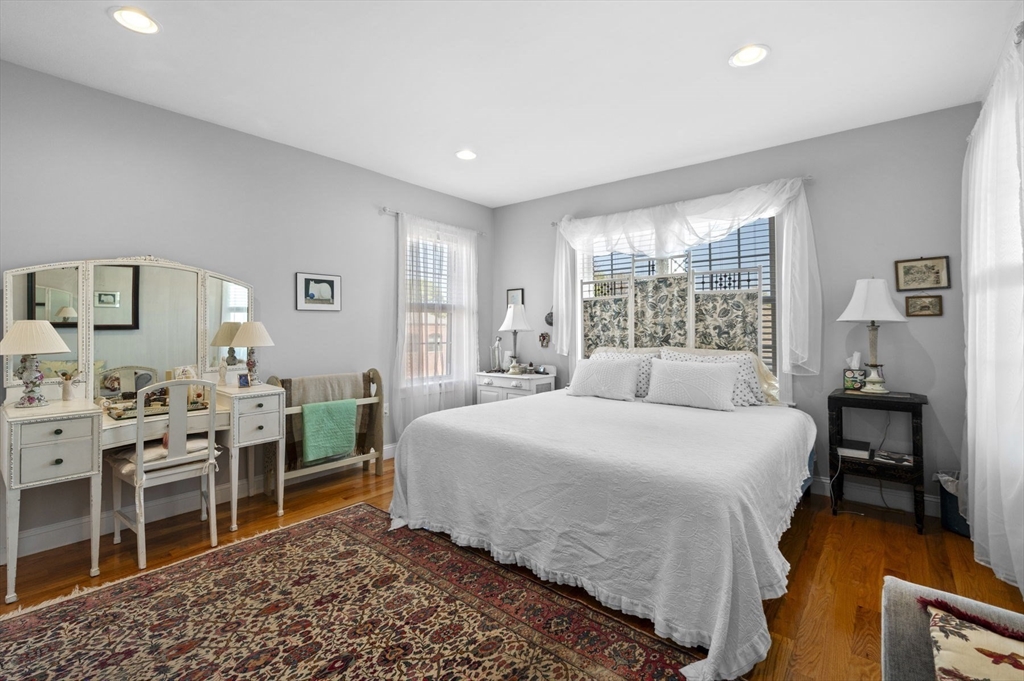 13 Spring Street, Unit 3 Salem, MA 01970 - Photo 24 of 37 a bedroom with a bed and a table in it