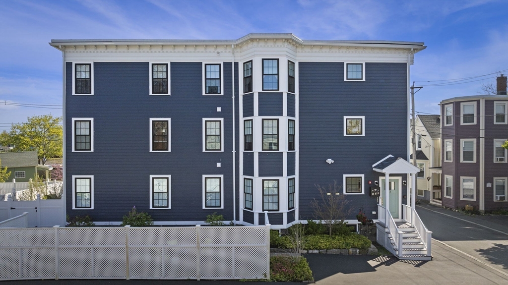 13 Spring Street, Unit 3 Salem, MA 01970 - Photo 29 of 37 a front view of a house with a yard