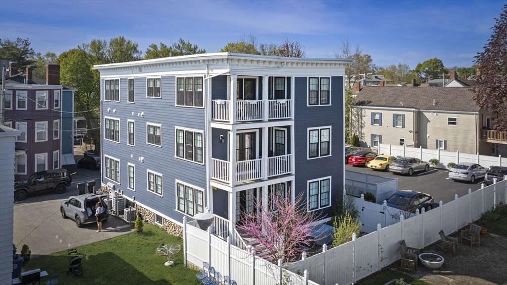 13 Spring Street, Unit 3 Salem, MA 01970 - Photo 30 of 37 a front view of a residential apartment building with a yard