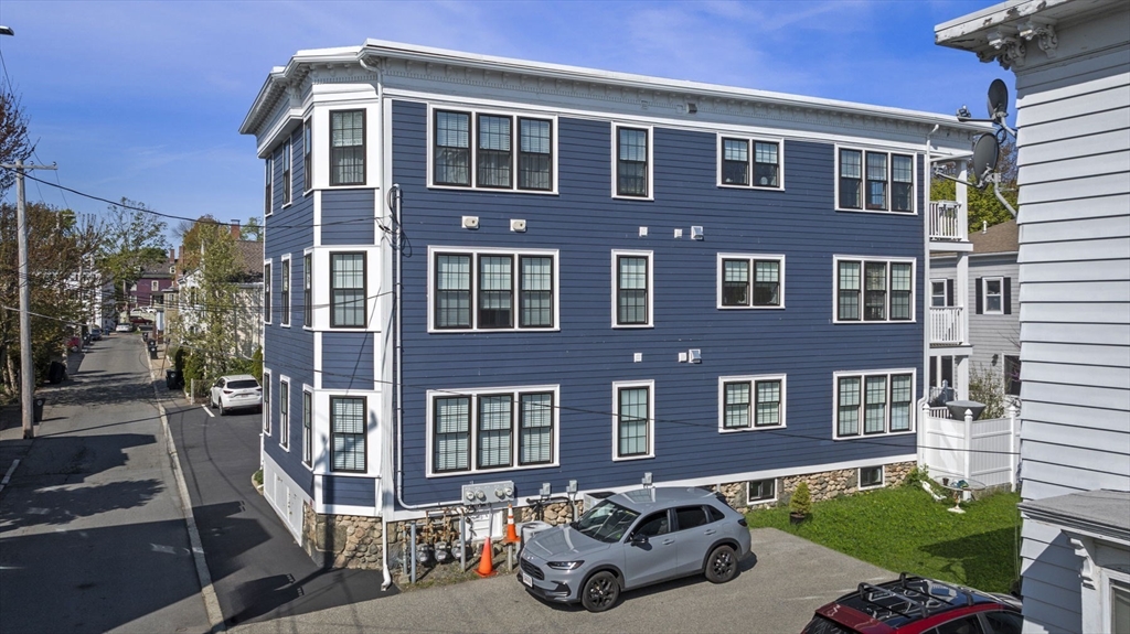 13 Spring Street, Unit 3 Salem, MA 01970 - Photo 32 of 37 a front view of a house with a yard
