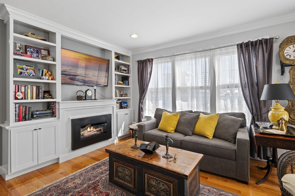 13 Spring Street, Unit 3 Salem, MA 01970 - Photo 8 of 37 a living room with furniture fireplace and a large window