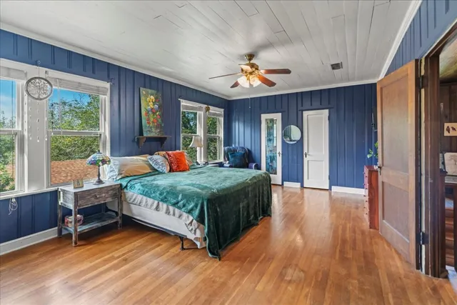 a bedroom with a bed and a large window