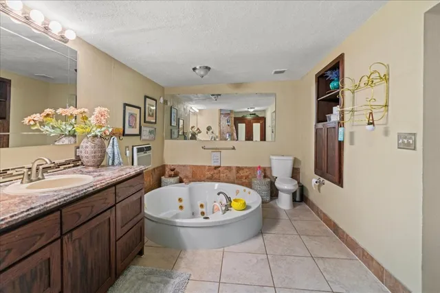 a bathroom with a tub sink and mirror
