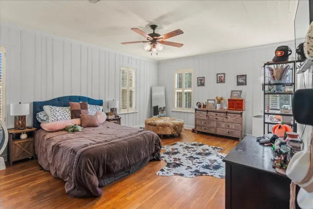 a bedroom with bed and a chandelier