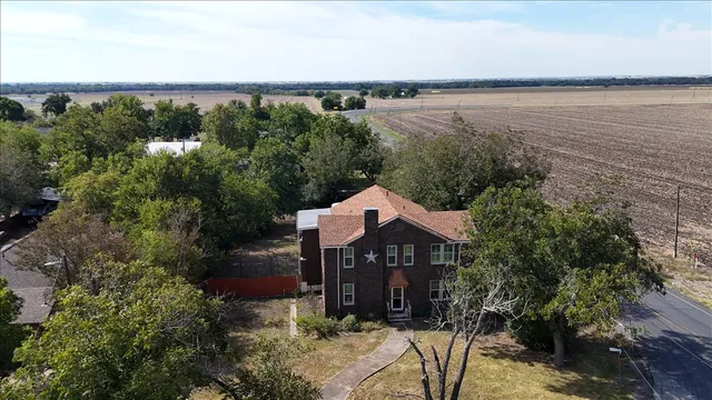 an aerial view of a house with a lake view