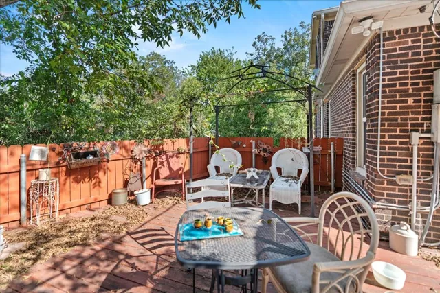 a backyard of a house with fire pit and outdoor seating
