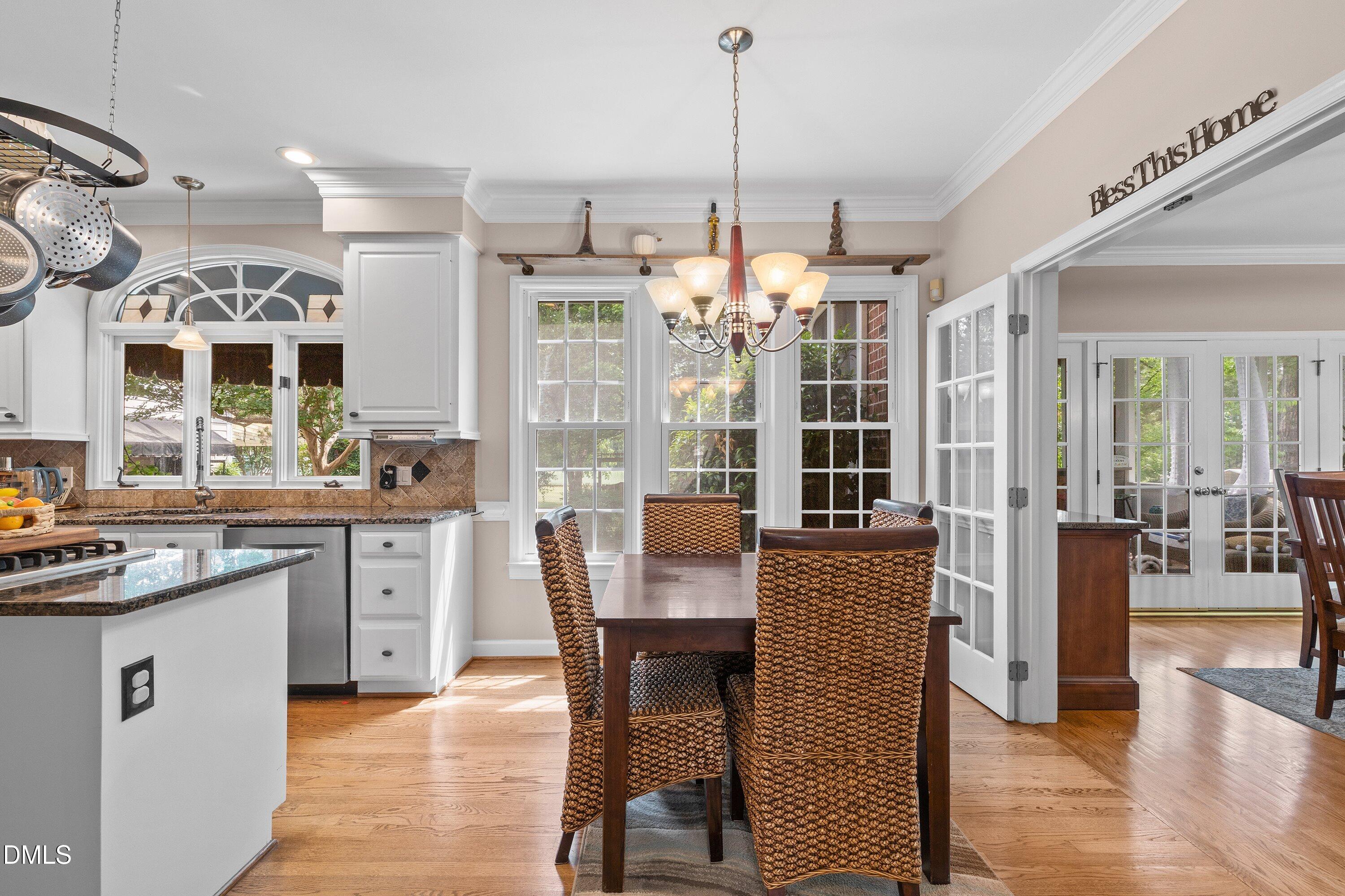 6612 Fowler Road Zebulon, NC 27597 - Photo 16 of 42 a kitchen with granite countertop cabinets a dining table and chairs