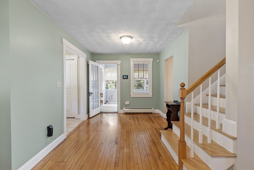 21 High Street Ayer, MA 01432 - Photo 13 of 41 a view of an entryway with wooden floor and stairs