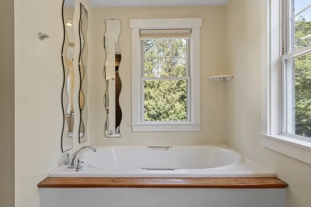 a bathroom with a bathtub and a window