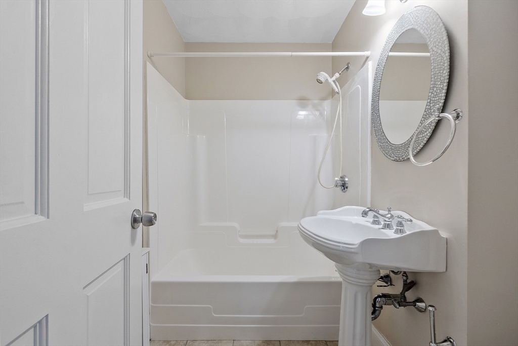 21 High Street Ayer, MA 01432 - Photo 18 of 40 a bathroom with a sink a mirror and a shower