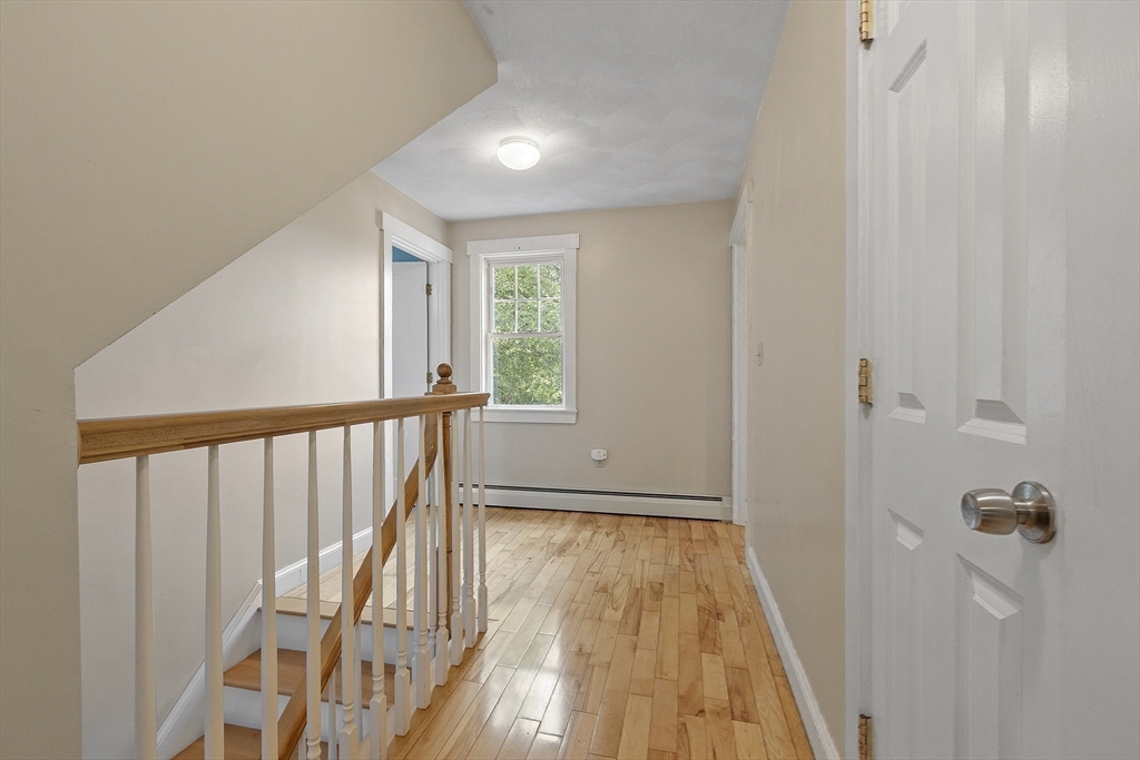 21 High Street Ayer, MA 01432 - Photo 20 of 41 a view of a hallway with wooden floor and staircase