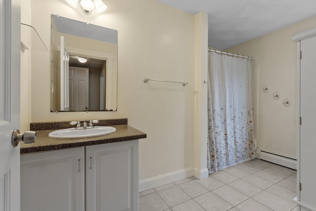 21 High Street Ayer, MA 01432 - Photo 23 of 40 a bathroom with a granite countertop sink and a mirror