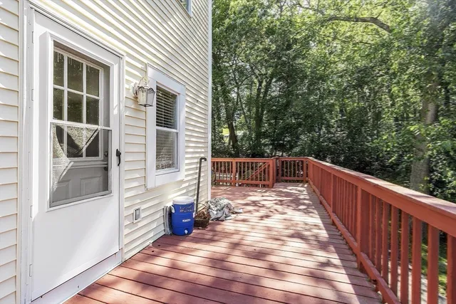 a view of a balcony with wooden floor and fence