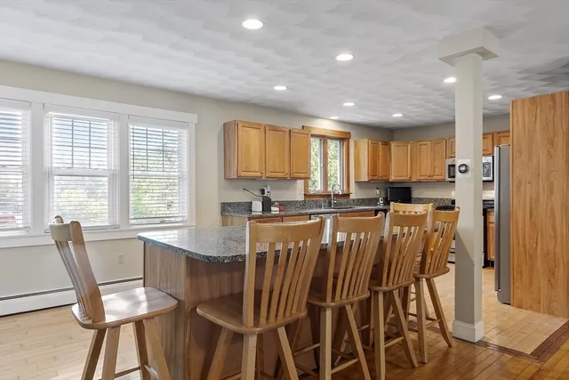 a view of a dining room with furniture and a window