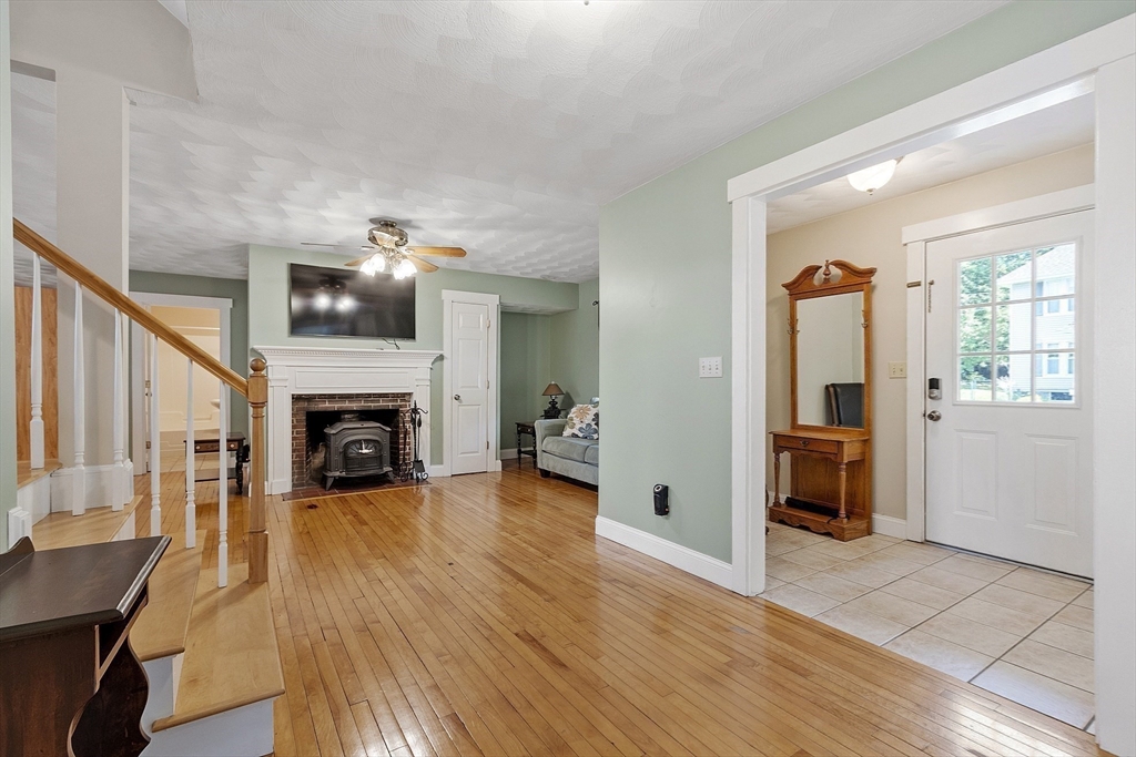 21 High Street Ayer, MA 01432 - Photo 9 of 40 a view of a livingroom with wooden floor and a fireplace