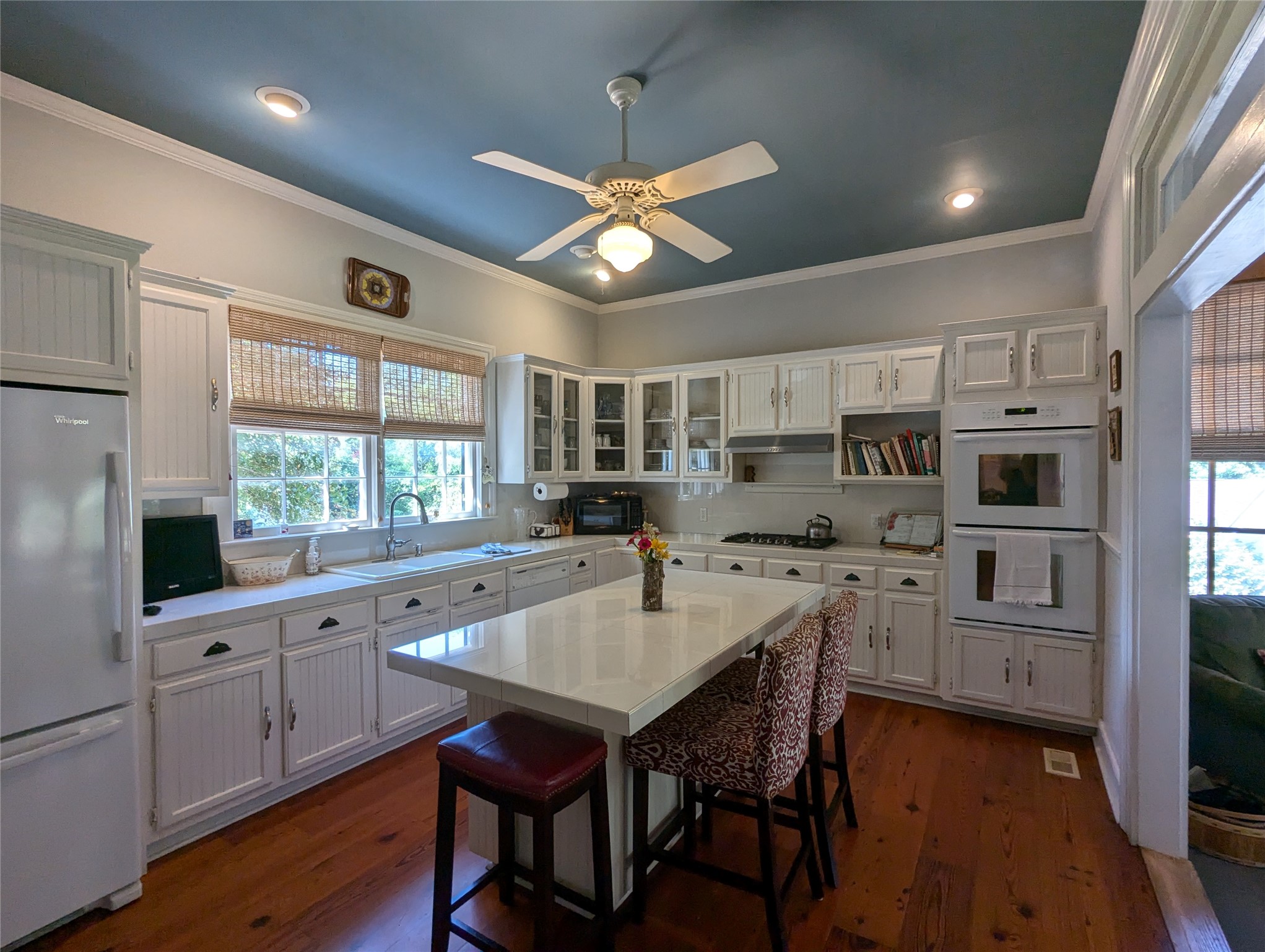 414 Spring Street Washington, GA 30673 - Photo 8 of 42 a kitchen with granite countertop a center island white cabinets and stainless steel appliances