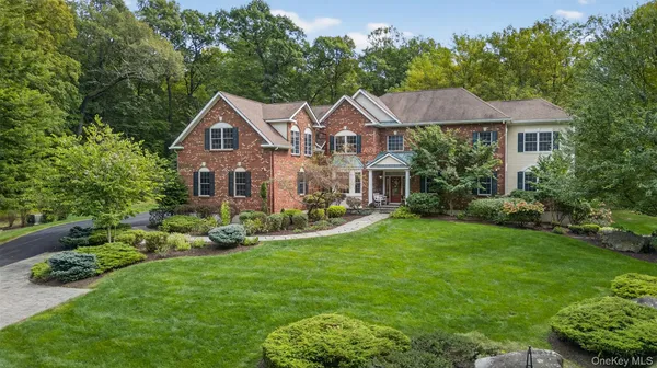 a front view of a house with a garden and plants