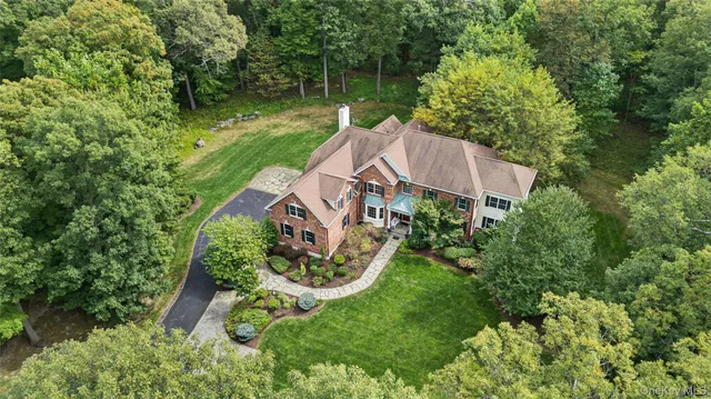an aerial view of a house with yard swimming pool and outdoor seating