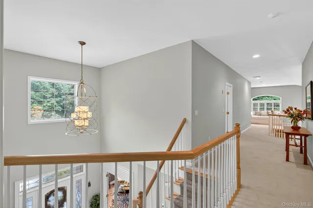 a living room with furniture and floor to ceiling windows
