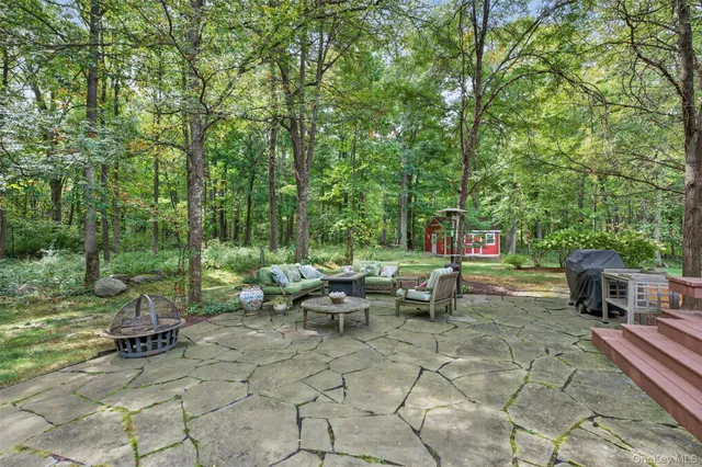 a front view of a house with patio and garden