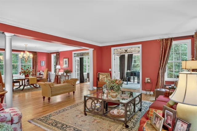 a living room with furniture fireplace and large windows