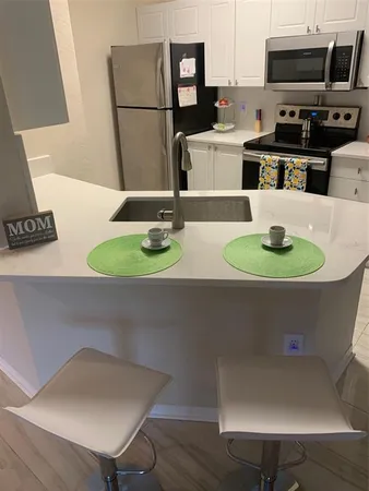 a kitchen with a table and chairs