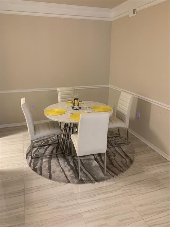 5140 Northridge Road, Unit 204 Sarasota, FL 34238 - Photo 7 of 12 a view of a dining room with furniture and wooden floor