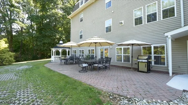 a view of a house with backyard porch and sitting area