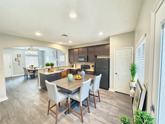 a view of a dining room with furniture window and wooden floor