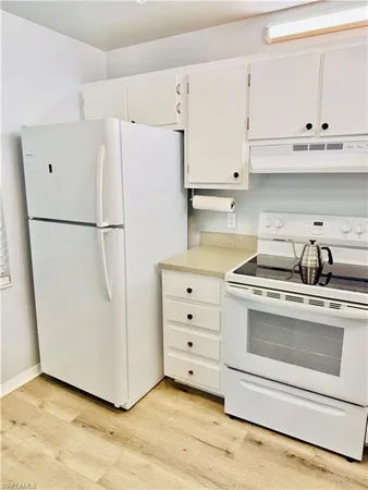 a white refrigerator freezer sitting in a kitchen