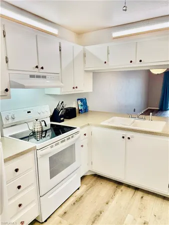 a view of cabinets with wooden floor