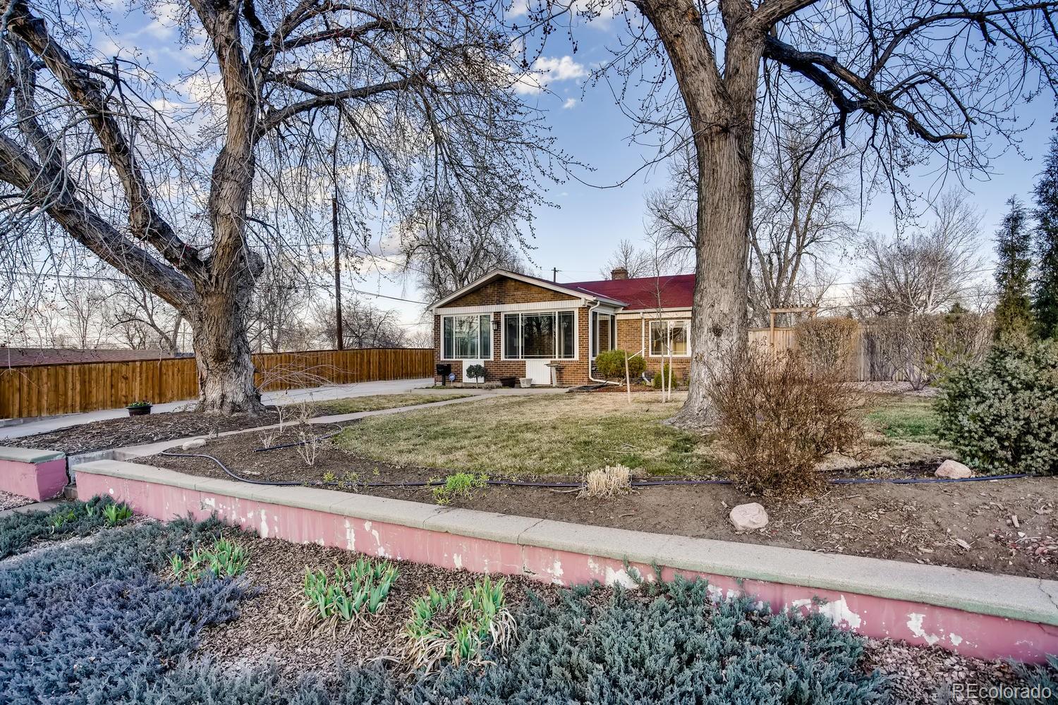 1718 South Decatur Street Denver, CO 80219 - Photo 1 of 28 a front view of a house with garden