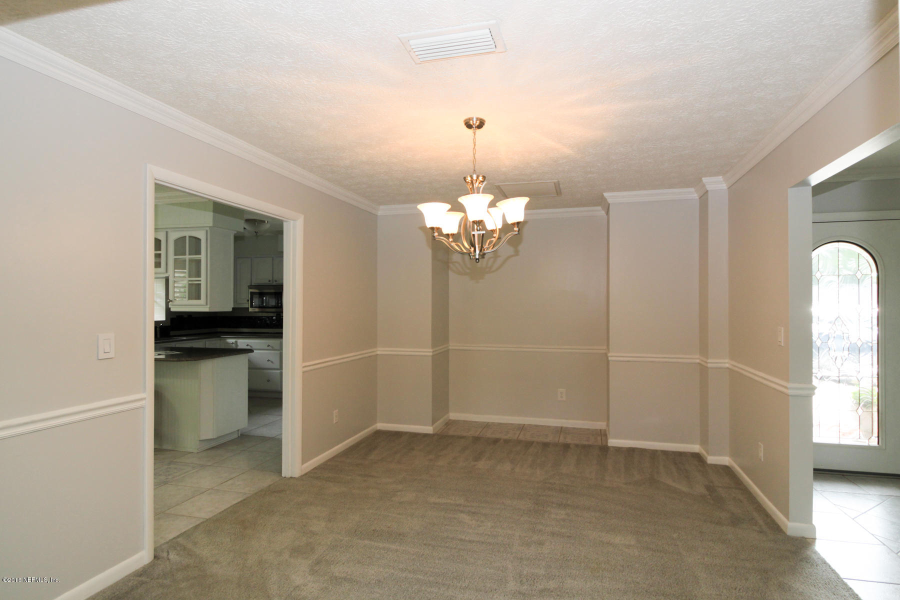 2015 Cornell Road Middleburg, FL 32068 - Photo 12 of 42 a view of a room with a windows and a chandelier