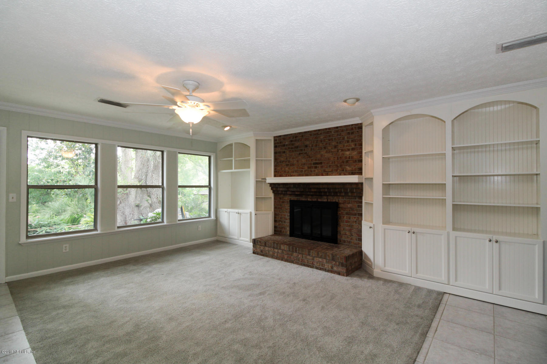 2015 Cornell Road Middleburg, FL 32068 - Photo 13 of 42 a view of an empty room with a fireplace and a window