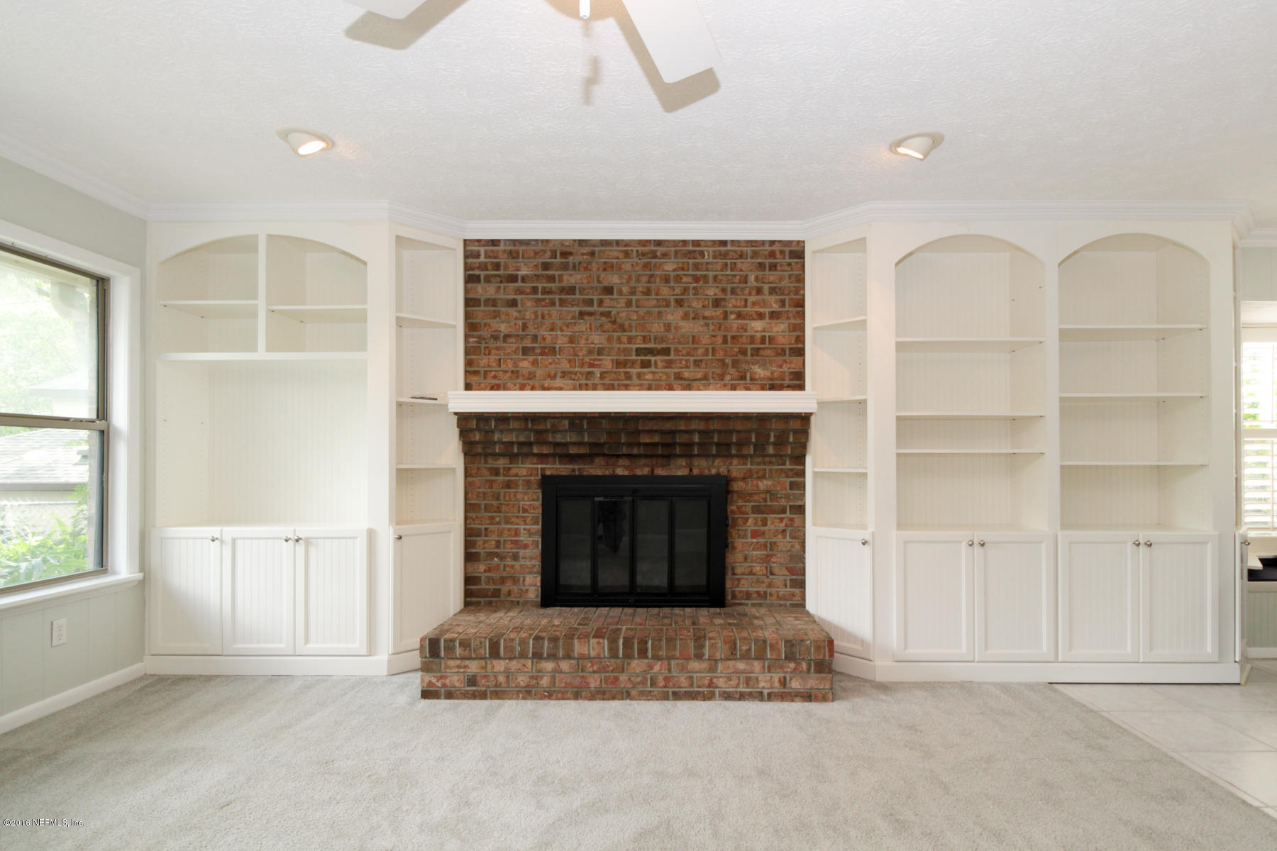 2015 Cornell Road Middleburg, FL 32068 - Photo 14 of 42 a living room with furniture and a fireplace