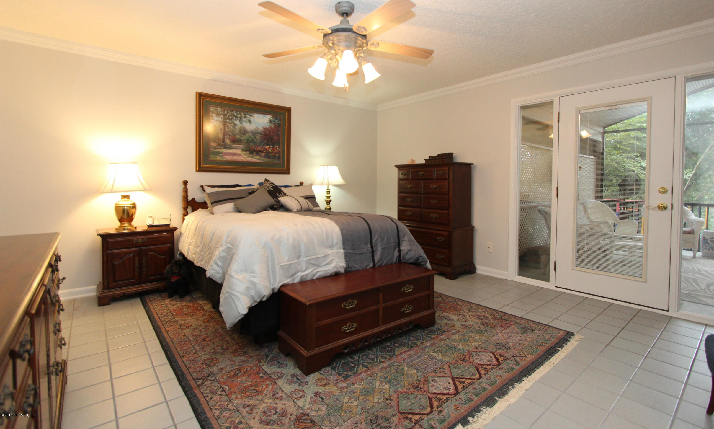 2015 Cornell Road Middleburg, FL 32068 - Photo 15 of 42 a bed room with a bed and a chandelier