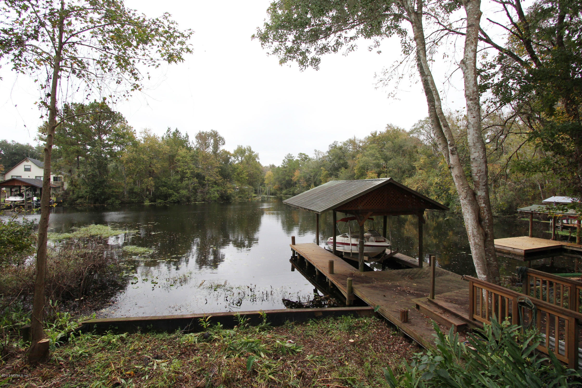 2015 Cornell Road Middleburg, FL 32068 - Photo 2 of 42 a view of a lake with a yard and large trees
