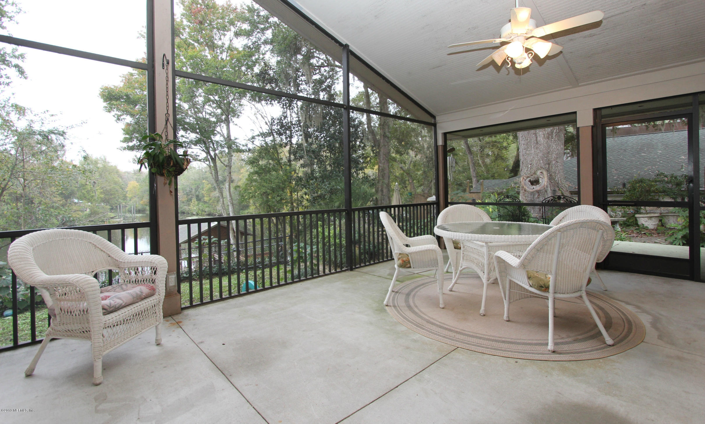 2015 Cornell Road Middleburg, FL 32068 - Photo 27 of 42 a dining room with furniture a chandelier and glass door