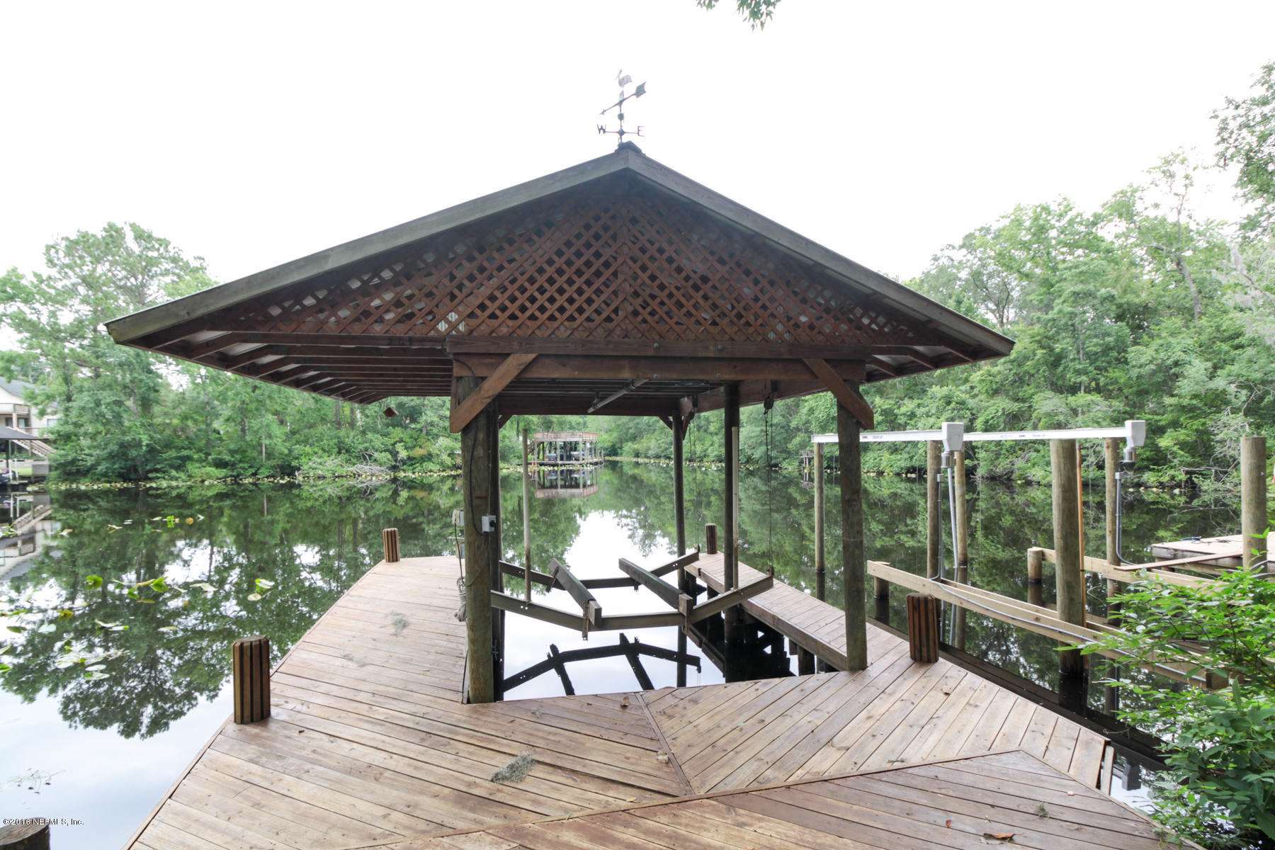 2015 Cornell Road Middleburg, FL 32068 - Photo 3 of 42 a roof deck with table and chairs under an umbrella