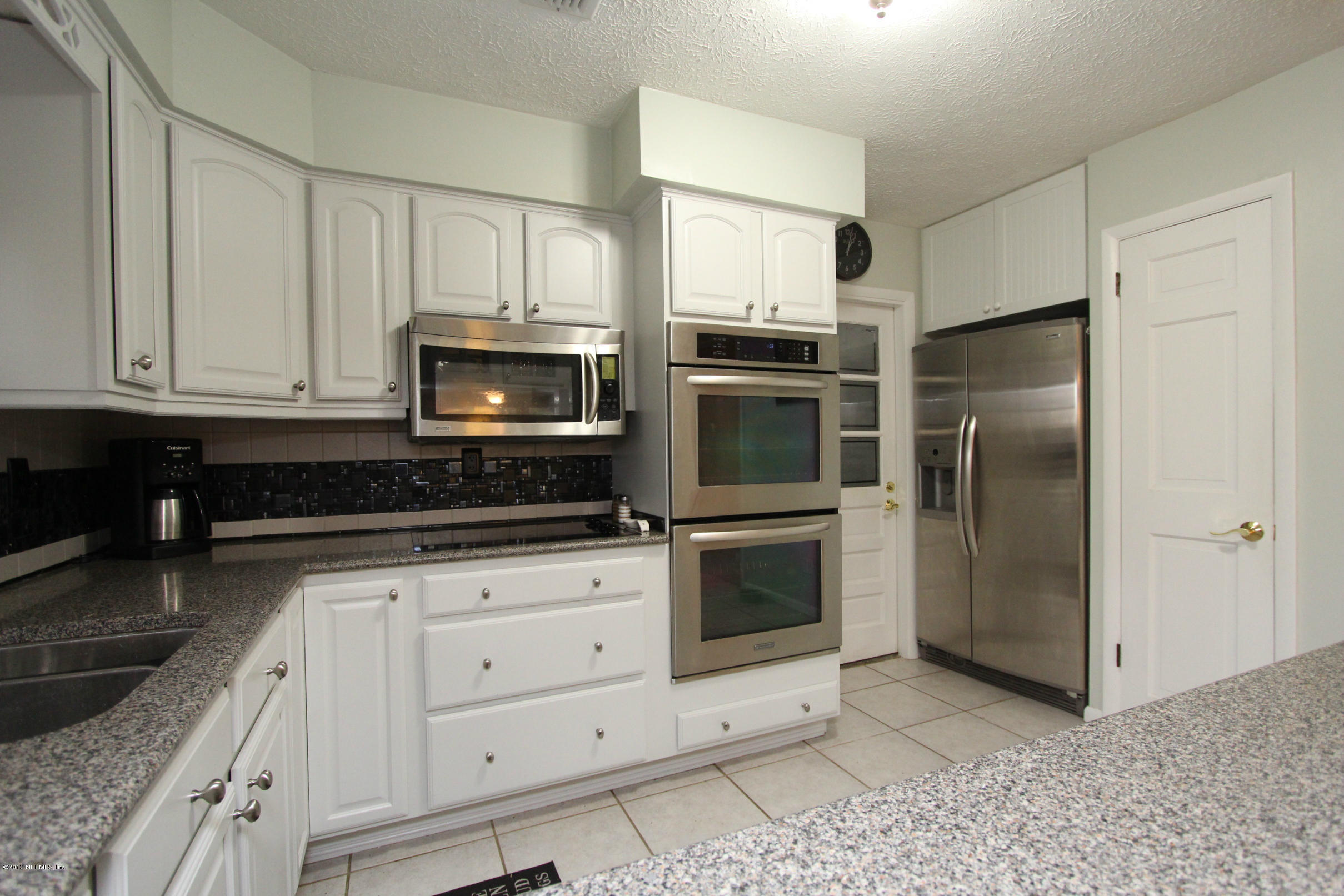 2015 Cornell Road Middleburg, FL 32068 - Photo 5 of 42 a kitchen with granite countertop white cabinets stainless steel appliances and a counter space