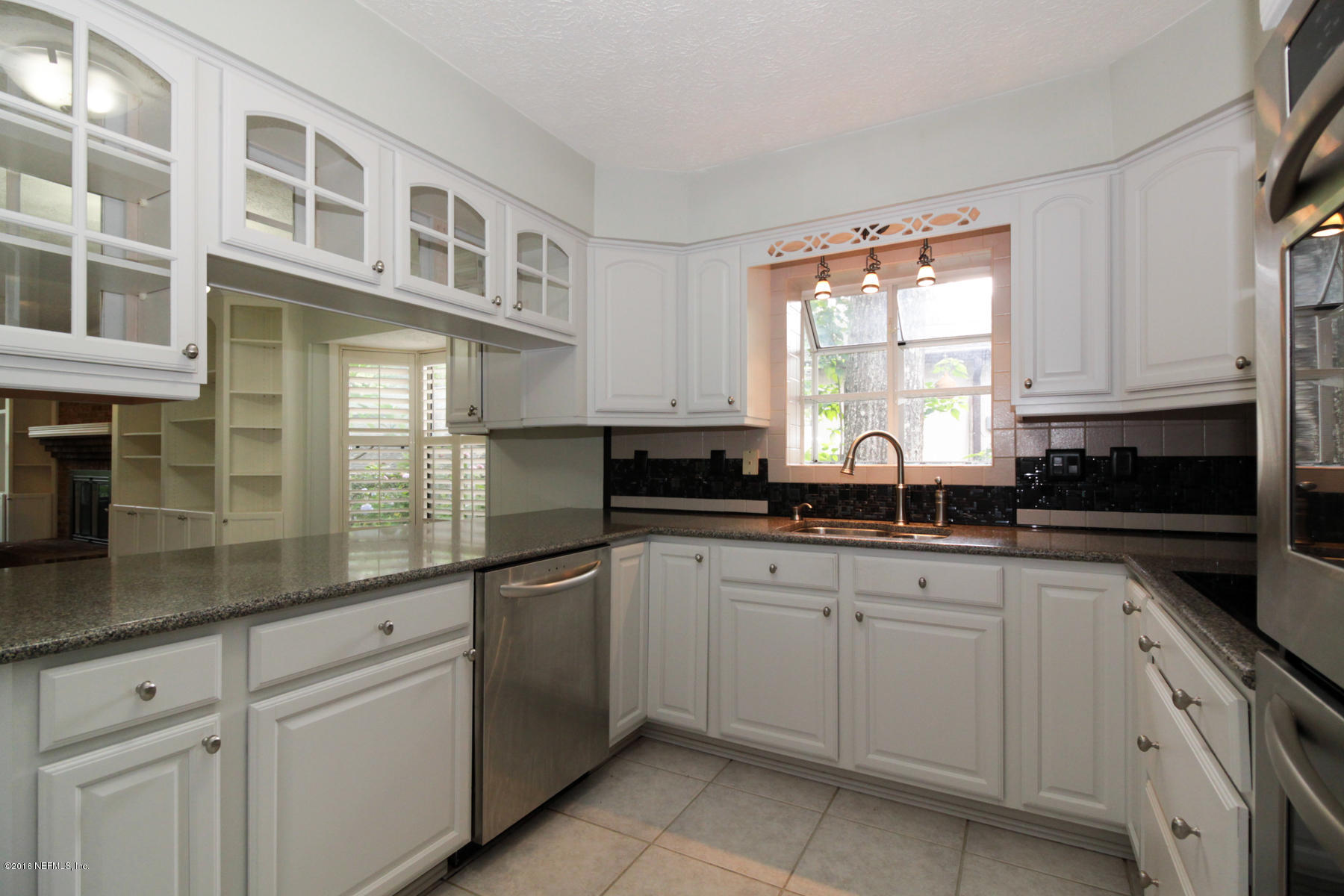 2015 Cornell Road Middleburg, FL 32068 - Photo 7 of 42 a kitchen with cabinets appliances a sink and a window
