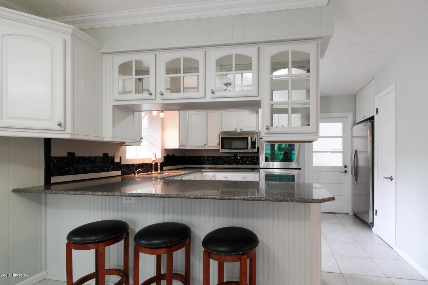 2015 Cornell Road Middleburg, FL 32068 - Photo 8 of 42 a kitchen with stainless steel appliances granite countertop a stove a sink and a refrigerator