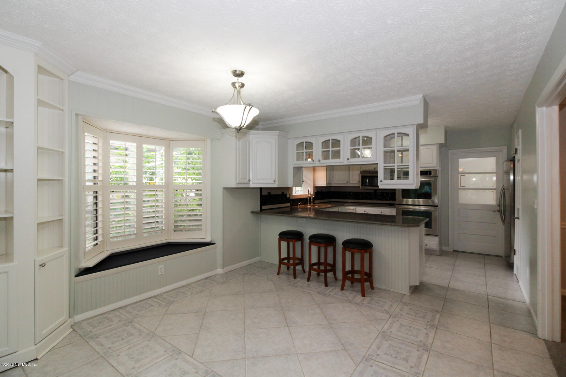 2015 Cornell Road Middleburg, FL 32068 - Photo 9 of 42 a kitchen with a counter top space a sink cabinets and appliances