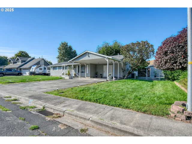 a view of a house with backyard sitting area and porch