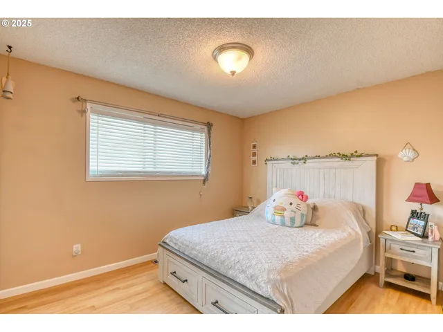 a backyard of a house with trees and outdoor seating
