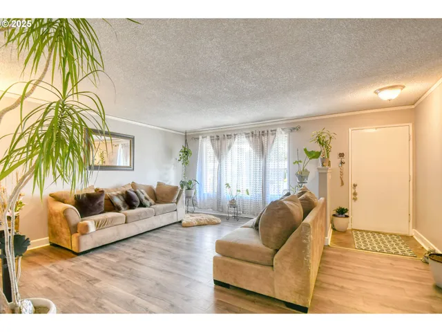 a view of a dining room with furniture and a chandelier