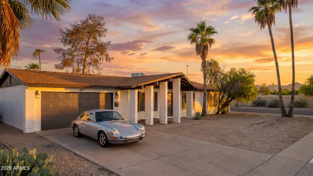 a car parked in front of white house
